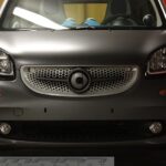 Front grille SLS in color titania grey matt with original Smart emblem for Smart Fortwo 453